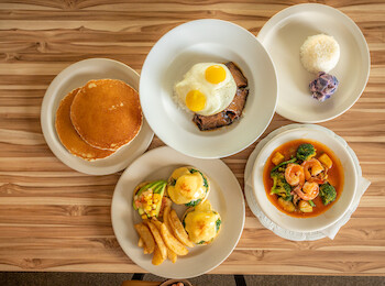 The image shows five plates of food, including pancakes, eggs with toast, rice, a dish with vegetables, and eggs Benedict with fries.